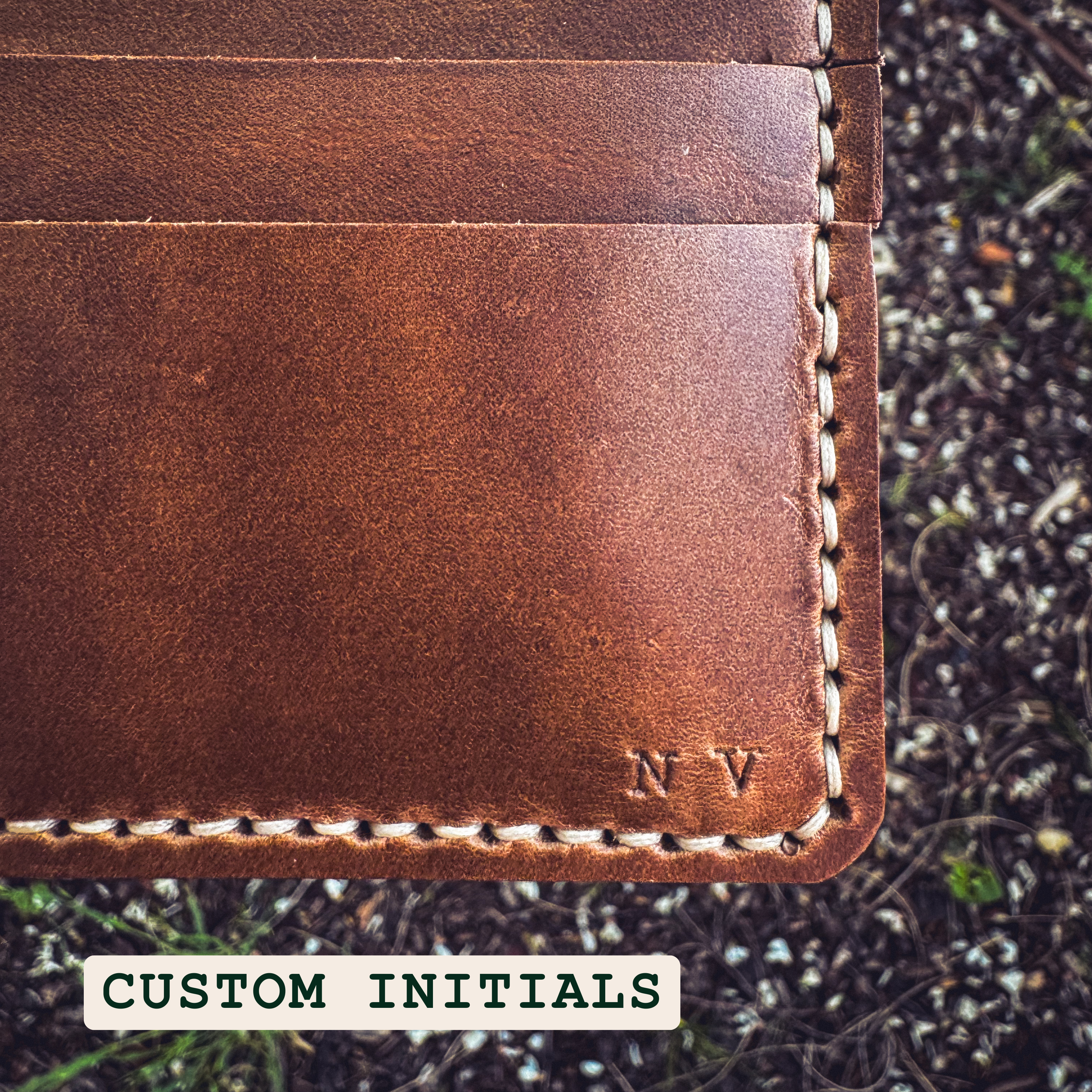 No. 2 Frontiersman Leather Bifold Wallet, Horween Natural Chromexcel Leather, Custom Initials laying on rugged ground