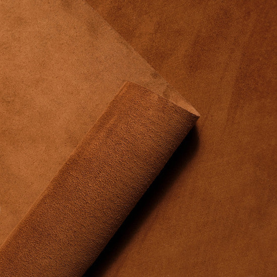 Rolled_suede_leather_hide_in_warm_terra_brown_showcasing_the_soft_velvety_nap_and_rich_texture_of_premium_Italian_suede_from_Opera_Conceria