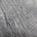 An extreme macro close-up of a raw Charred Earth Wild African Kudu leather hide, showcasing its rugged natural grain, deep organic striations, and unique wild habitat scars in ashy grey and charcoal tones.