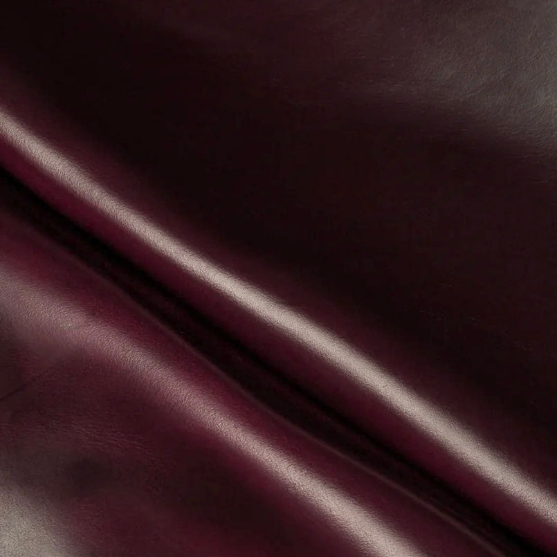 Detailed macro texture shot highlighting the deep burgundy tones and characteristic pull-up effect of premium Horween Chromexcel leather.