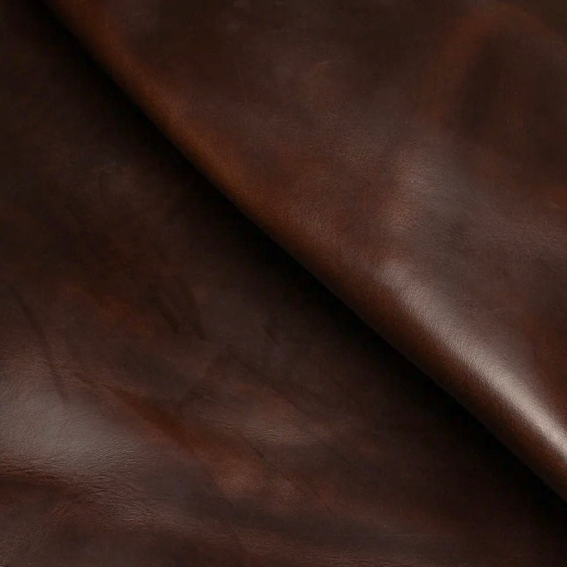 Detailed macro texture shot highlighting the rich dark brown tones and characteristic pull-up effect of premium Horween Chromexcel leather.