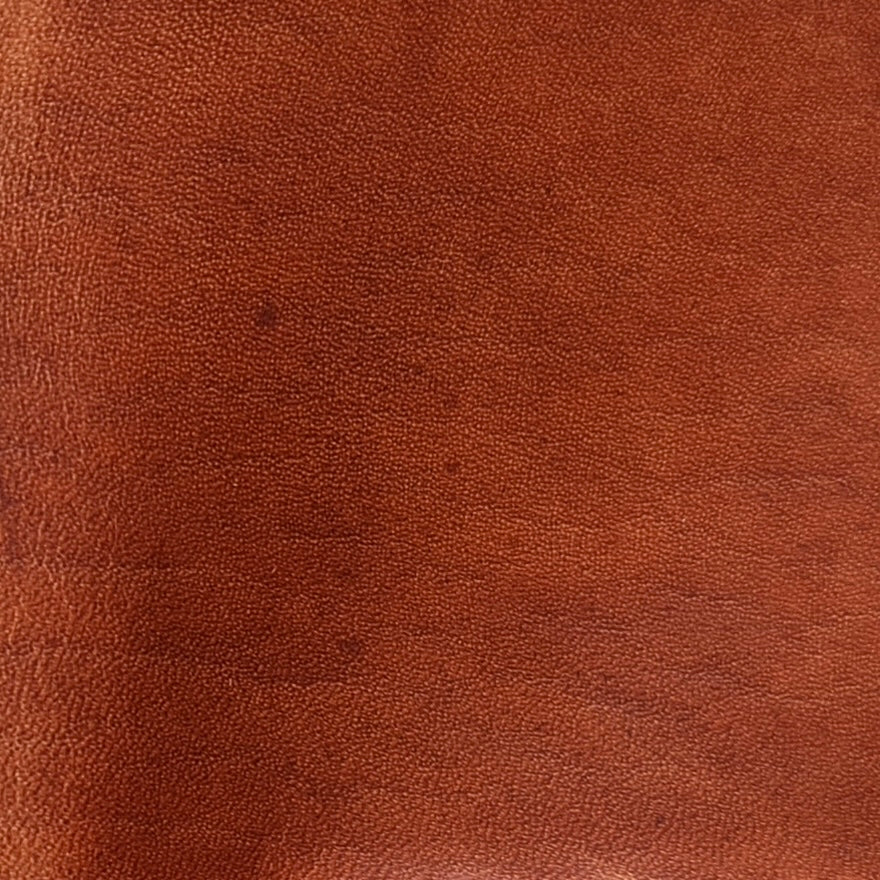 Close-up view of premium Horween Dublin leather in English Tan, highlighting the rich, natural grain, warm color saturation, and the signature luxurious finish of this world-renowned tannery hide.