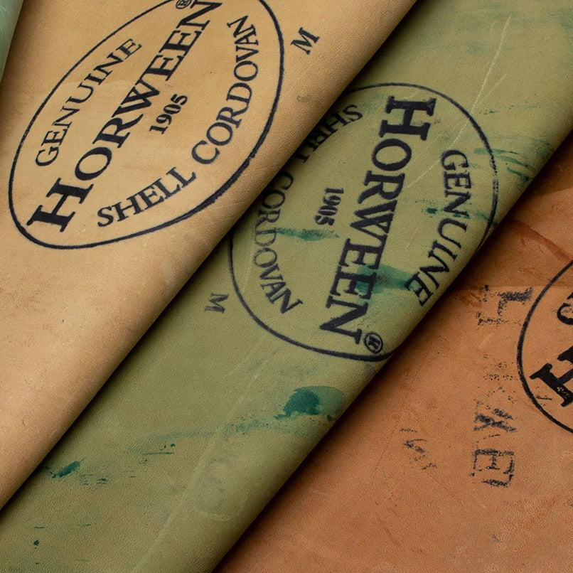 Close-up view of the reverse side of multiple premium Horween Shell Cordovan leather hides, each featuring the authentic Genuine Horween Shell Cordovan 1905 maker's stamp.