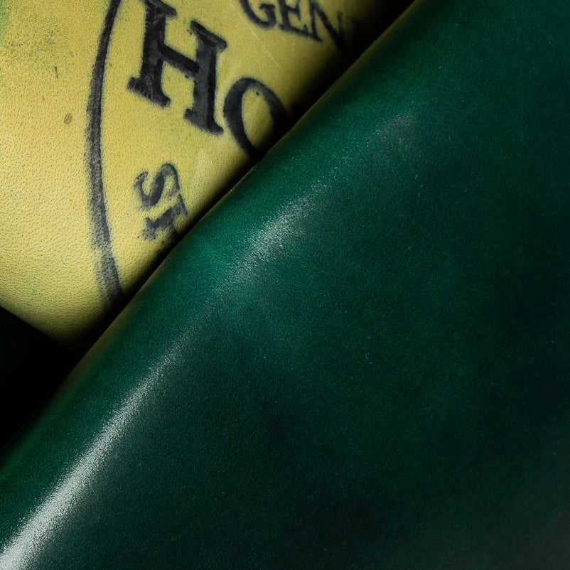 Close-up detail shot of premium Horween Green Shell Cordovan leather, showcasing the authentic Horween maker's stamp on the reverse side.