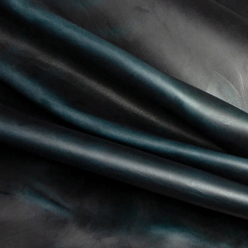 Detailed macro texture shot highlighting the deep navy blue tones and characteristic pull-up effect of premium Horween Chromexcel leather.