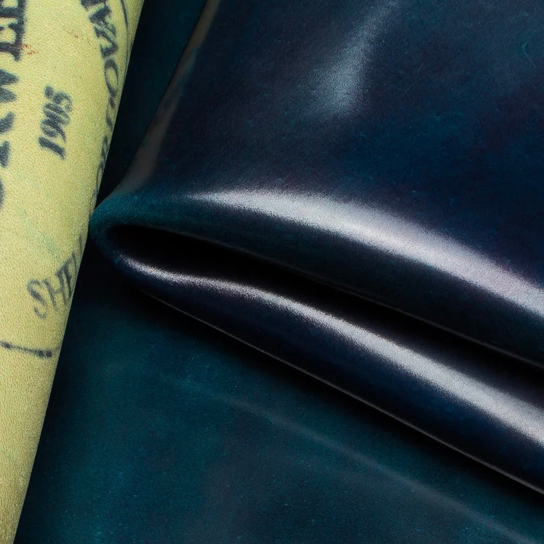 Detailed macro texture shot highlighting the deep navy blue tones and smooth, dense grain of premium Horween Shell Cordovan leather.