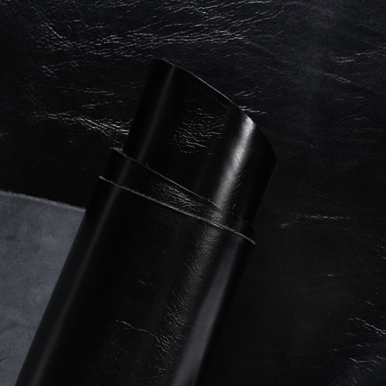 Close-up view of premium Black Invecchiato leather from La Bretagna, highlighting the rich, natural grain, depth of color, and the smooth, luxurious finish of this high-quality hide.