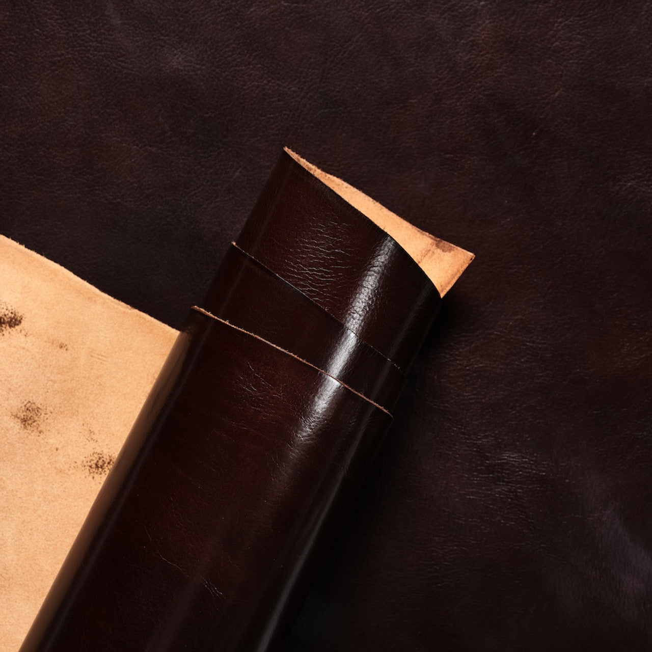 Close-up view of premium Tuscan Brown Invecchiato leather from La Bretagna, highlighting the rich, natural grain, depth of color, and the smooth, luxurious finish of this high-quality hide.