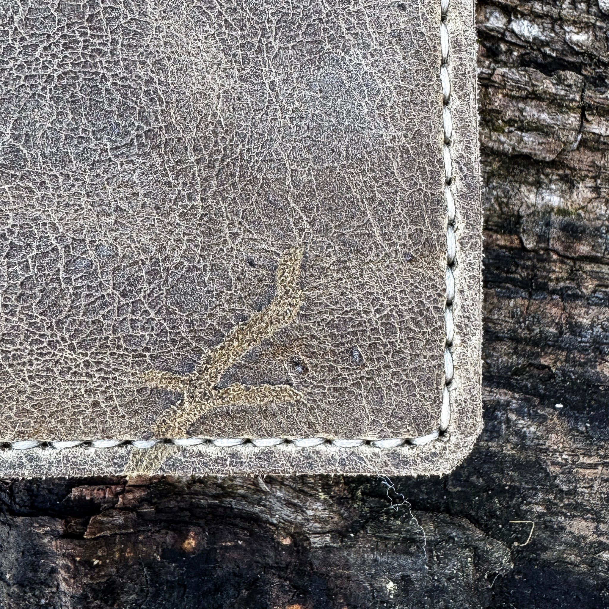 Close-up detail of the handcrafted No. 1652 JAGTER field bifold wallet in Desert color Wild African Kudu leather, highlighting rugged natural hide markings and durable hand-stitching.