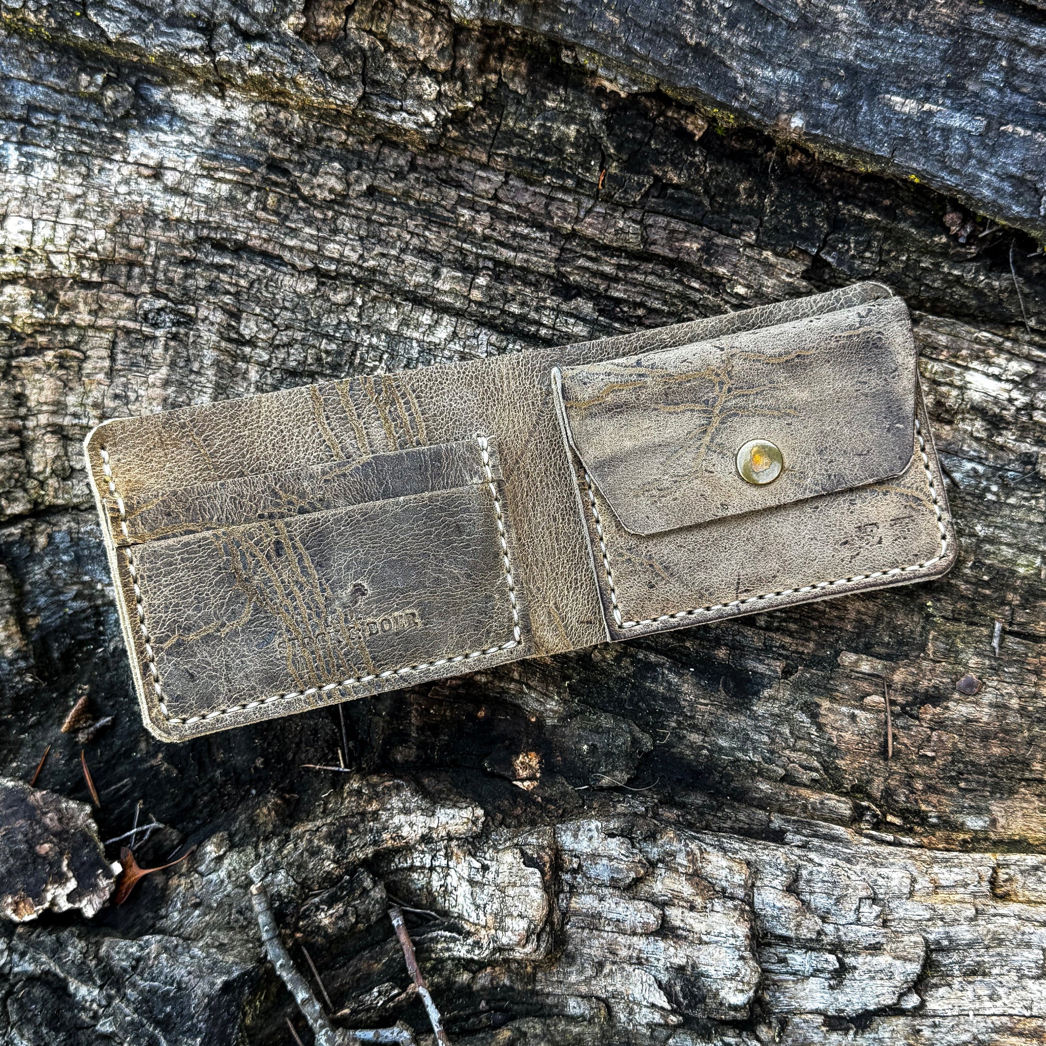 Interior view of the handcrafted No. 1652 JAGTER field bifold wallet in Wild African Kudu leather, featuring rugged card slots and a secure snap-closure coin pouch.