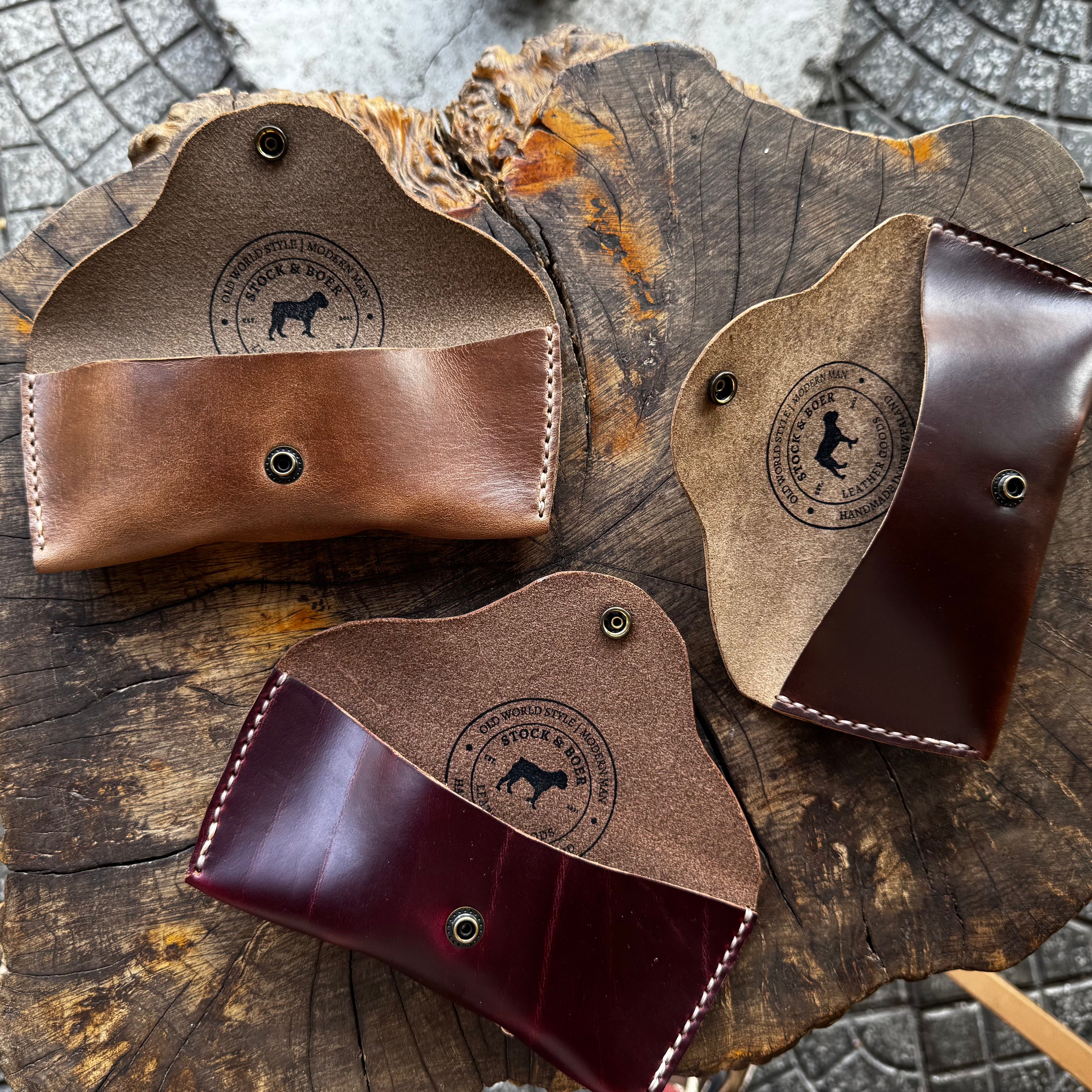 Three open No. 7 DESPERADO Sunglass Cases in natural, brown, and burgundy Horween Chromexcel leather, arranged together on a tree stump.
Screenshot 2026-06-06 at 8.33.41 pm.jpg